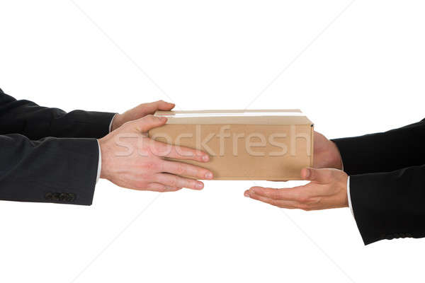 Businessman Giving Box To His Colleague Stock photo © AndreyPopov