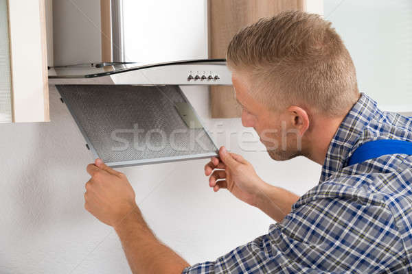 Repairman Repairing Kitchen Extractor Filter Stock photo © AndreyPopov
