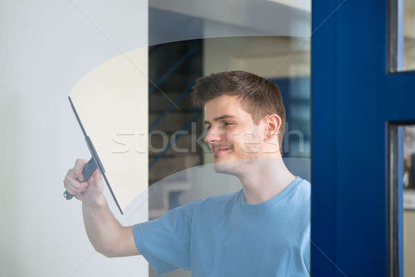 Worker Cleaning Glass With Squeegee Stock photo © AndreyPopov