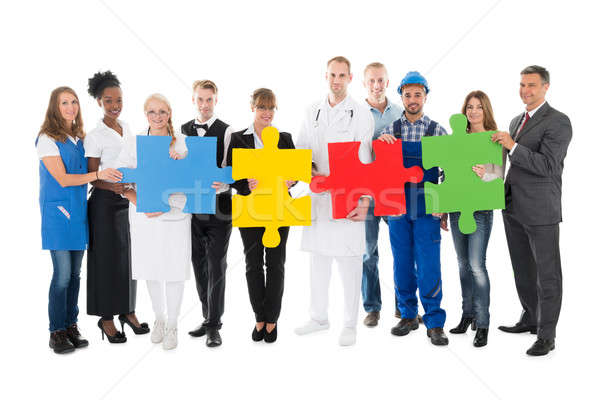 Confident People With Various Occupations Holding Jigsaw Pieces Stock photo © AndreyPopov