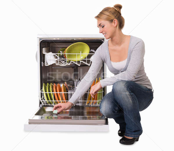 Young Woman Placing Soap In Dishwasher Stock photo © AndreyPopov