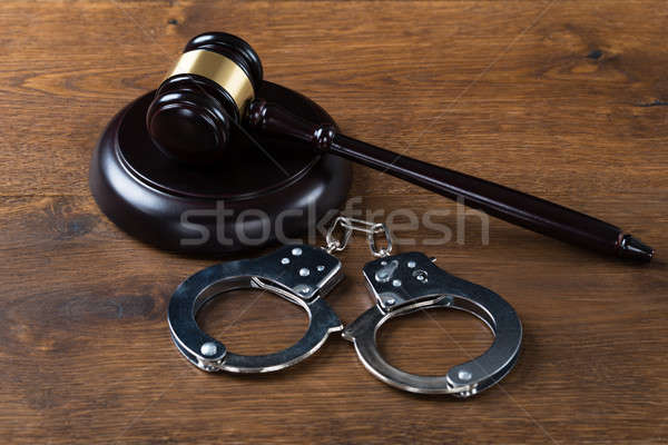 Mallet And Handcuffs On Table In Courtroom Stock photo © AndreyPopov