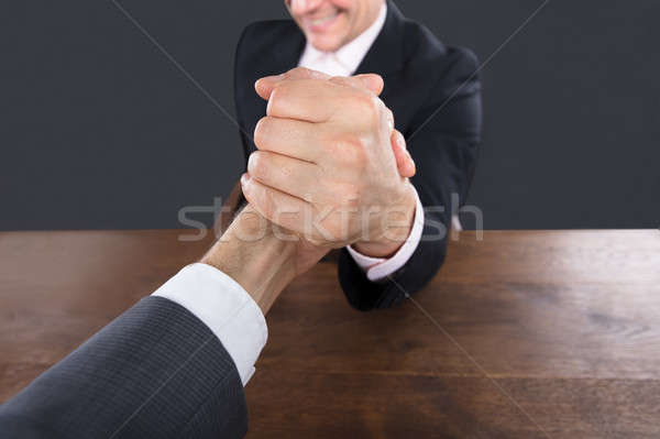 Stock photo: Two Businessman Competing In Arm Wrestling