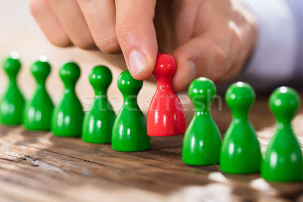 Person Placing Red Figures In Row Stock photo © AndreyPopov