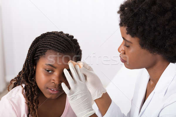 Stock photo: Doctor Applying Band Aid To Girl Head