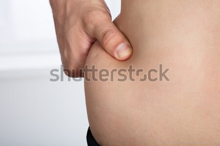 Woman Pinching Excessive Stomach Fat Stock photo © AndreyPopov