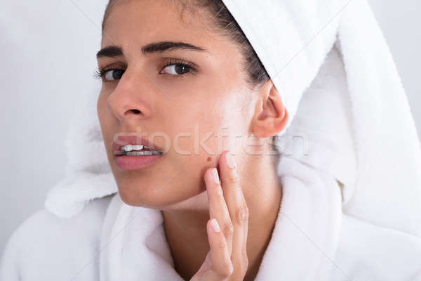 Young Woman Looking At Pimple And Squeezing Stock photo © AndreyPopov