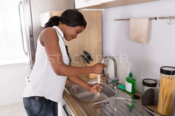 Woman Using Plunger In Blocked Kitchen Sink Stock photo © AndreyPopov