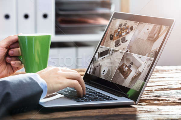 Businessperson Monitoring Video Footage On Laptop Stock photo © AndreyPopov