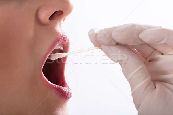 Dentist Taking Saliva Test Of A Patient Stock photo © AndreyPopov