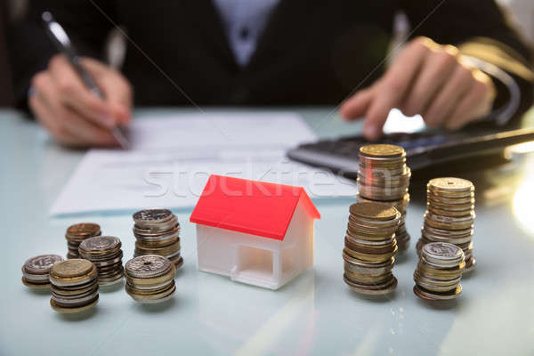 Close-up Of House Model And Stacked Coins On Desk Stock photo © AndreyPopov