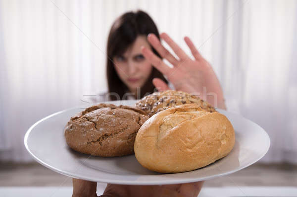 Woman Refusing Plate Of Bread And Cookies Stock photo © AndreyPopov