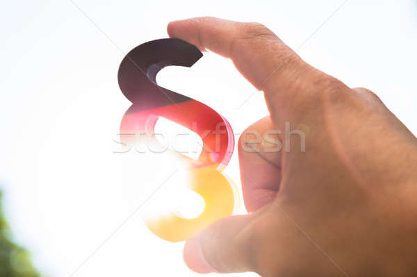 Human hand holding german paragraph symbol Stock photo © AndreyPopov