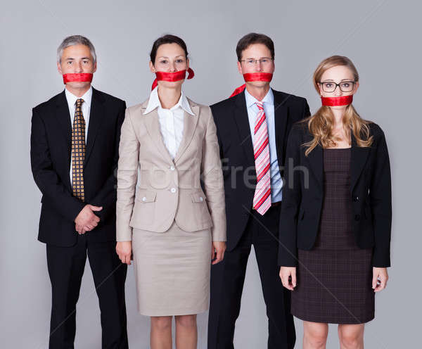 Businesspeople bound by red tape Stock photo © AndreyPopov