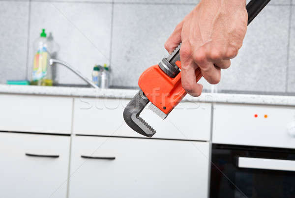 Plumber Fixing Sink In Kitchen Stock photo © AndreyPopov
