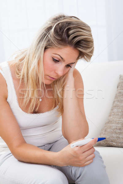 Worried woman checking pregnancy test Stock photo © AndreyPopov