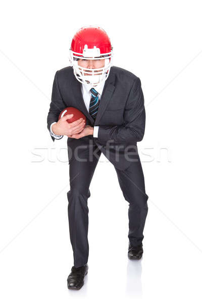 Competitive businessman playing american football Stock photo © AndreyPopov