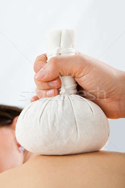 Woman Receiving Massage With Herbal Compress Bags At Spa Stock photo © AndreyPopov
