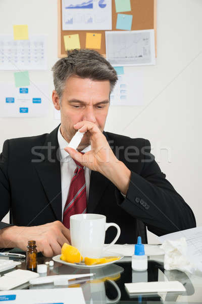 Businessman Spraying Nasal Spray In His Nose Stock photo © AndreyPopov