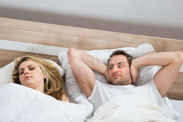 Man Covering Ears While Woman Sleeping Stock photo © AndreyPopov