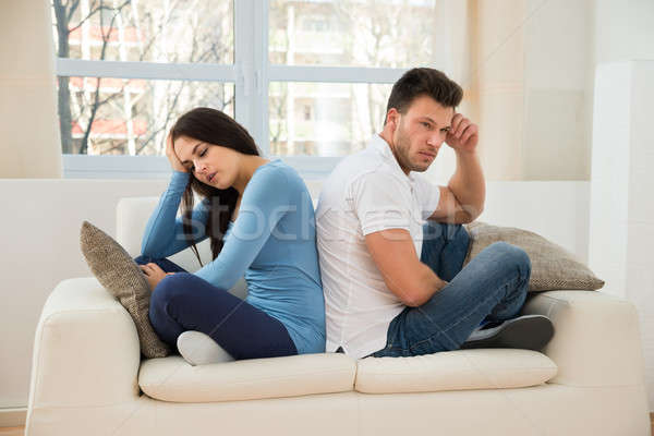 Displeased Couple Sitting On Couch After Quarrel Stock photo © AndreyPopov