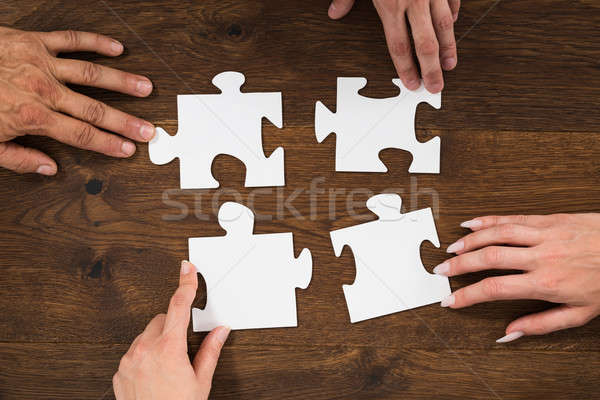 Emberi kezek kapcsolódik puzzle darab magasról fotózva Stock fotó © AndreyPopov