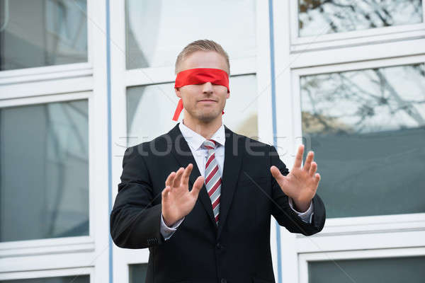 Blindfolded Businessman Standing Against Window Stock photo © AndreyPopov