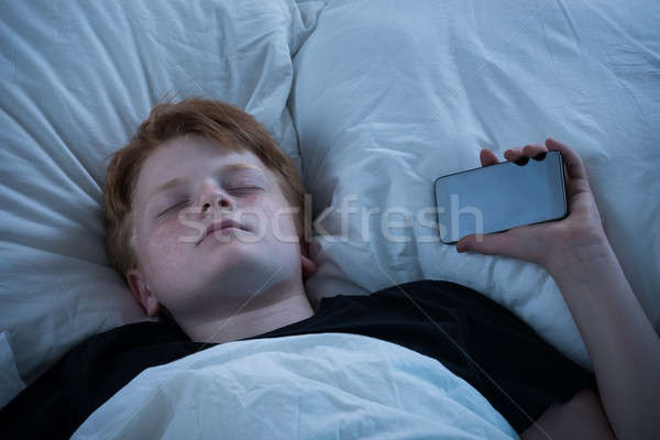 Stock photo: Boy Sleeping On Bed