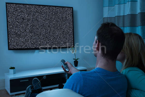 Couple With Remote Control Watching Television Stock photo © AndreyPopov