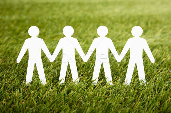 Stock photo: Papercut Of People Chain On Grass