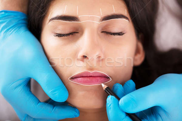 Cosmetologist Applying Permanent Make Up Stock photo © AndreyPopov