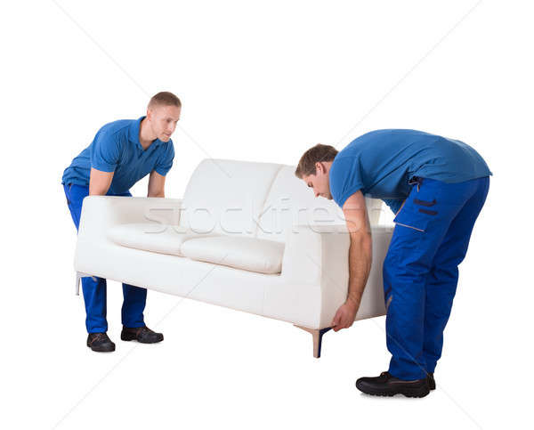 Young Professional Movers Placing The Sofa In New Home Stock photo © AndreyPopov