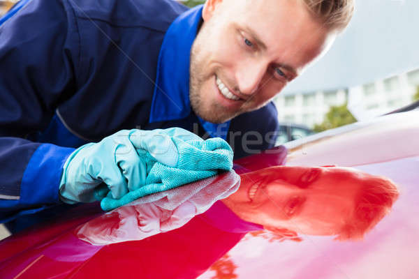 Happy Male Worker Cleaning Red Car Stock photo © AndreyPopov