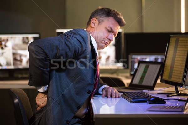 Imprenditore sofferenza mal di schiena vista laterale maturo ufficio Foto d'archivio © AndreyPopov