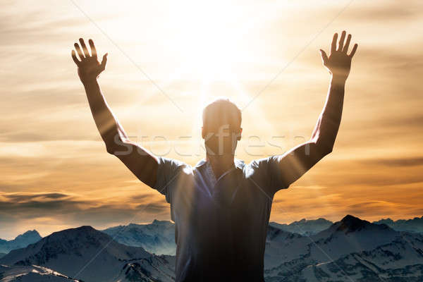 Homem braço pôr do sol montanha paisagem adorar Foto stock © AndreyPopov