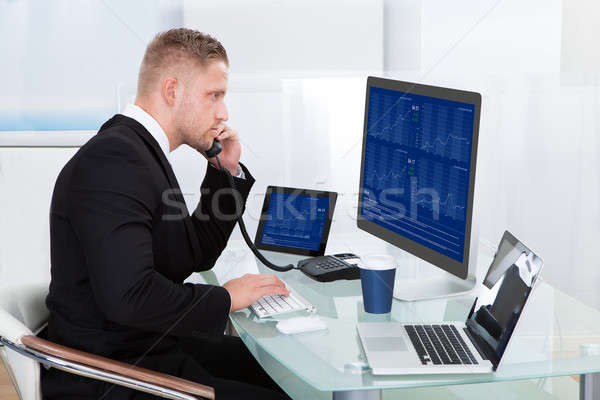 Hardworking businessman at his desk Stock photo © AndreyPopov