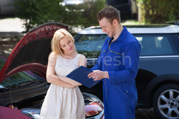 Mechanic Showing Clipboard To Customer By Breakdown Car Stock photo © AndreyPopov