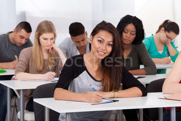 Female College Student Sitting At Desk Stock Photo C Andriy Popov