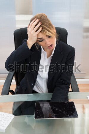 Businesswoman Looking At Broken Digital Tablet Stock photo © AndreyPopov