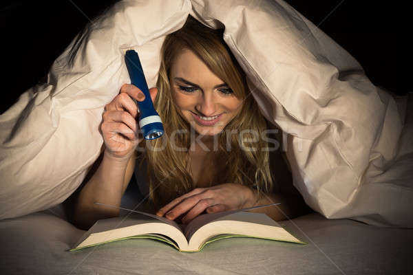 Woman Reading Book Holding Torch Stock photo © AndreyPopov