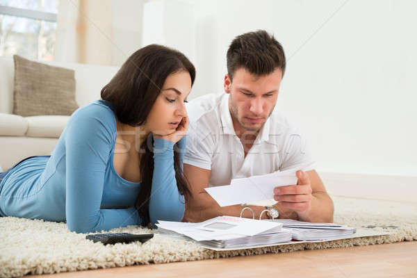 Worried Young Couple Calculating Their Bills At Home Stock photo © AndreyPopov