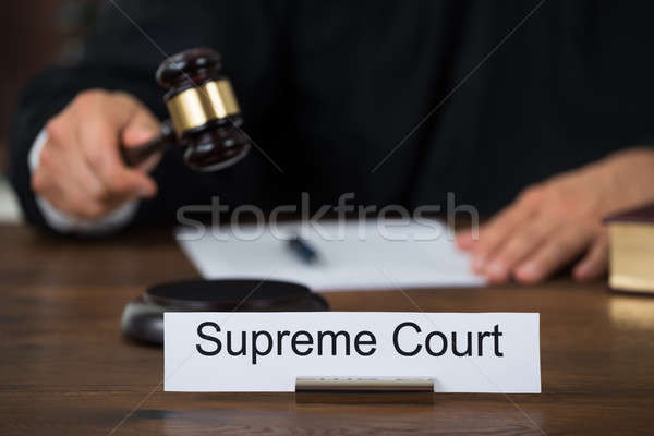 Supreme Court Nameplate With Judge Writing On Paper Stock photo © AndreyPopov