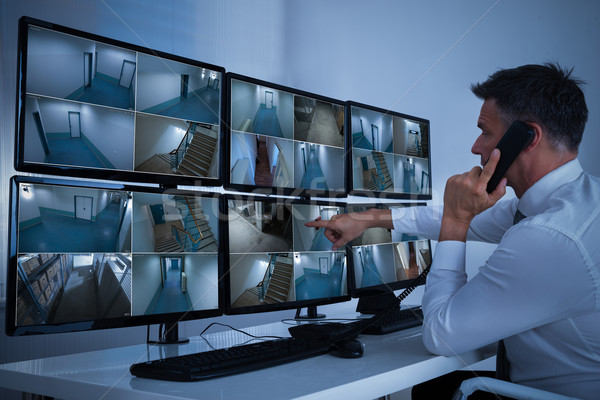 Security System Operator Looking At CCTV Footage Stock photo © AndreyPopov