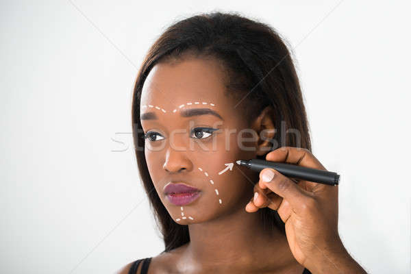 Person's Hand Drawing Correction Line On Woman's Face Stock photo © AndreyPopov