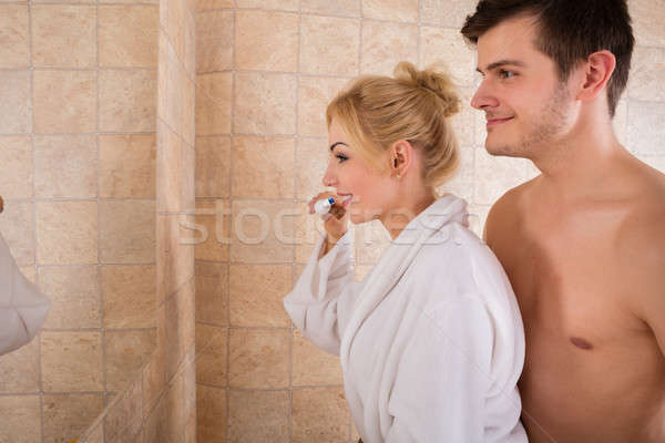 Young Couple Brushing Teeth In Bathroom Stock photo © AndreyPopov