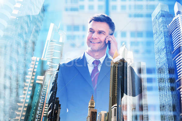 Confident Businessman Talking On Mobile Phone Stock photo © AndreyPopov