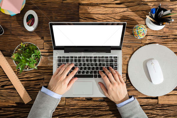 Kilátás üzletember laptopot használ fehér képernyő iroda Stock fotó © AndreyPopov