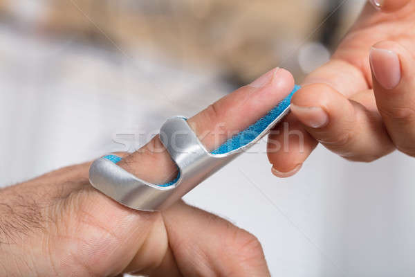 Physician Holding Person's Finger With Brace Stock photo © AndreyPopov