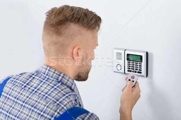 Repairman Using Remote To Operate Security System Stock photo © AndreyPopov
