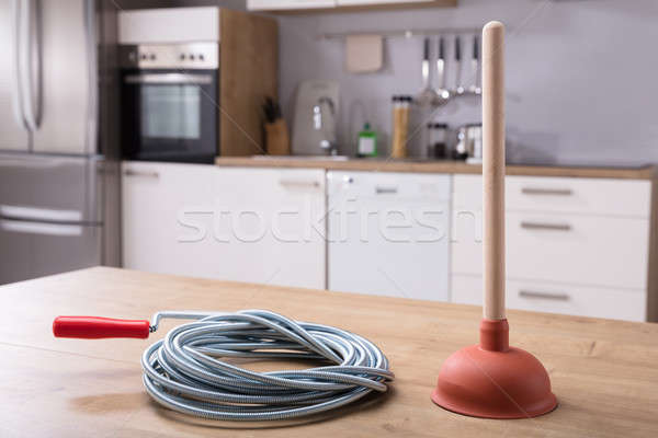 Closeup Of Man Using Plunger In Kitchen Sink Stock Photo, Picture and  Royalty Free Image. Image 23490896.